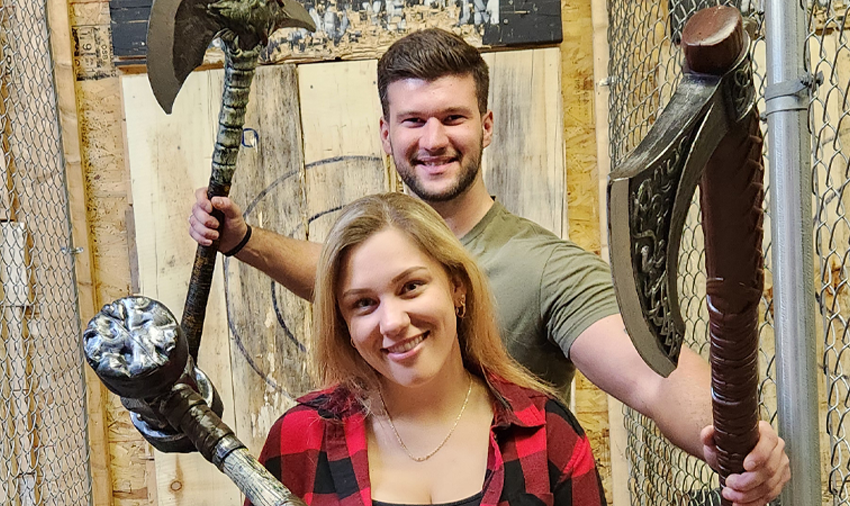 A couple enjoying axe throwing at the Agawam Axe House - an axe throwing bar in Agawam MA